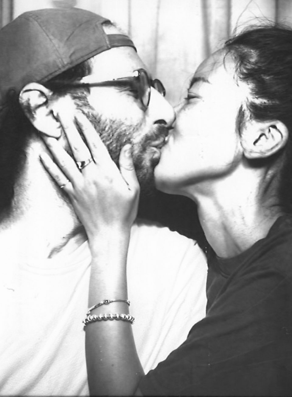 Yumin and Phil kissing in a photo booth